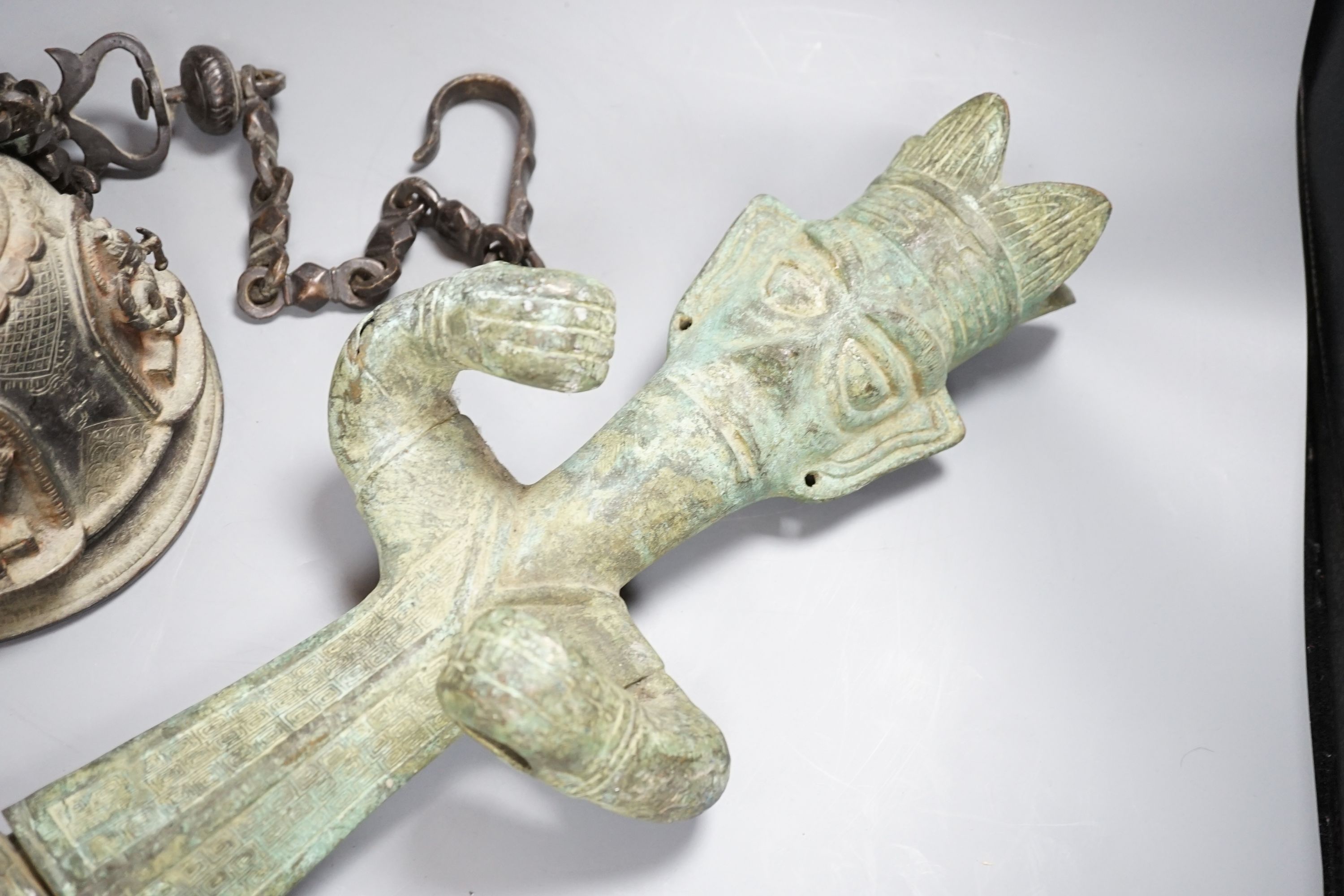 A large, archaic tic bronze figure, 76cm, and a bronze bell on chain